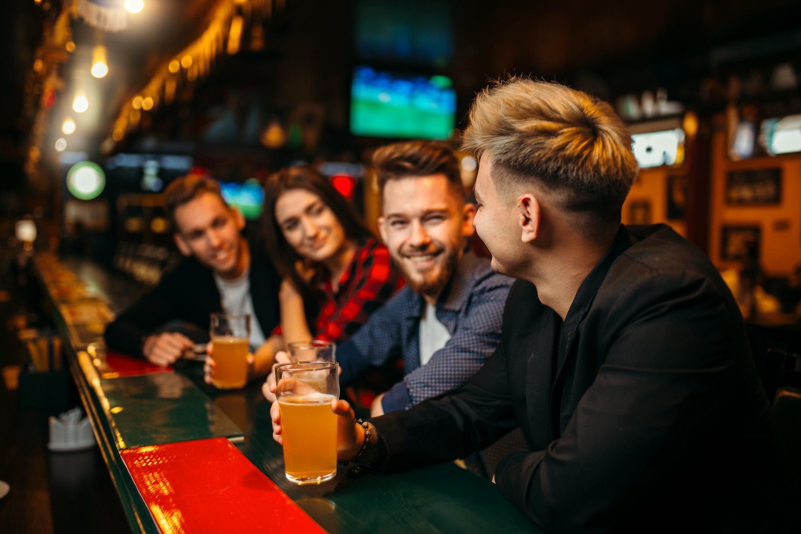 Happy football fans raised their glasses with beer